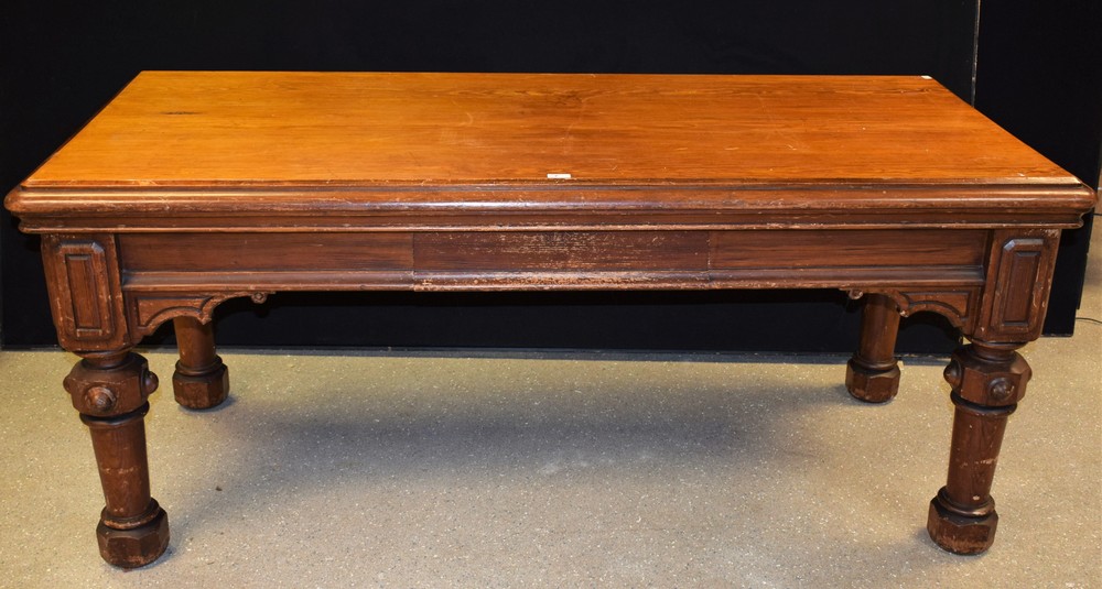 A Gothic Revival pitch pine library table, rounded rectangular top above a single frieze drawer,
