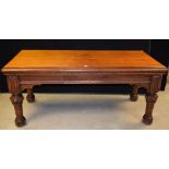 A Gothic Revival pitch pine library table, rounded rectangular top above a single frieze drawer,