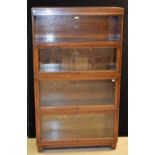 A Globe Wernicke bookcase, open shelf above three horizontal hinged and retractable glazed doors,