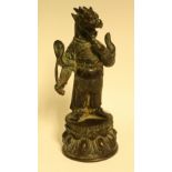 A Tibeten bronze, the beast stands on a lotus,