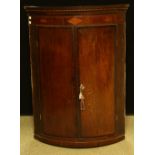 A George III mahogany corner cupboard, c.