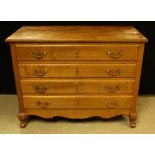 A Louis XV style oak commode, slightly oversailing rectangular top above four long drawers,
