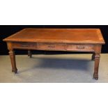 A substantial oak library table/desk, moulded rectangular top with inset writing surface,