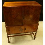 A Queen Anne style walnut cabinet on stand, c.