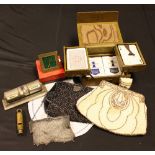 A silver mesh purse; a beaded evening bag; another; a travel clock; a perpetual desk calendar;