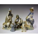 A Lladro figure girl stroking a seated dog, ND1246, caeres and rest, designed by Juan Huerta,