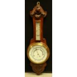 An early 20th century oak aneroid barometer