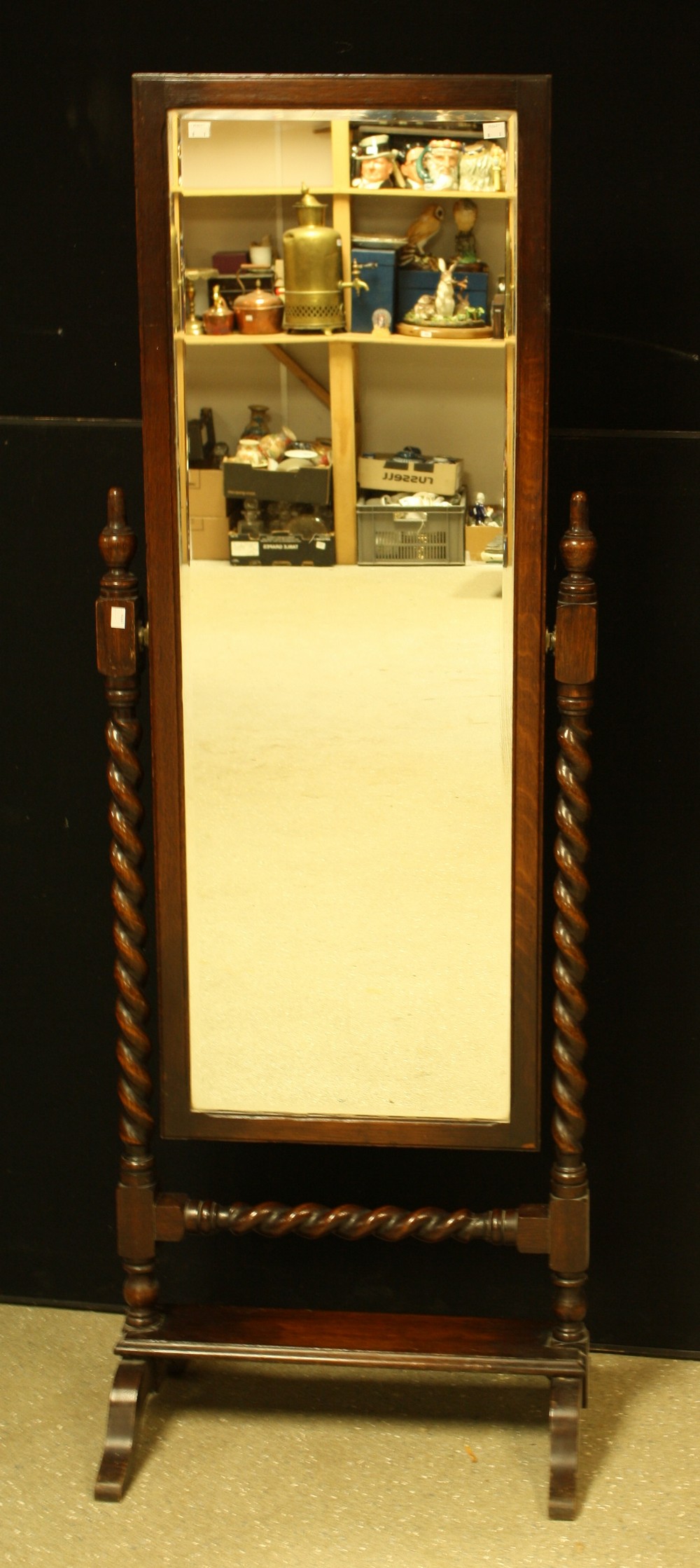 An early-mid 20th century oak cheval mirror, spirally turned supports,