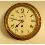 An Olsen's Grimsby brass circular wall clock, Roman numerals,