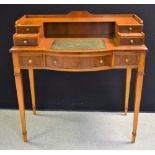 A yew Carlton House type writing desk, shaped and stepped superstructure with small drawers,