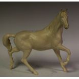 A Beswick model of a horse, leg up, head up,