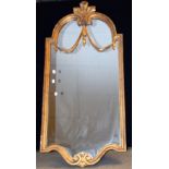 A Regency style arched rectangular wall mirror, ornate gilt frame, swag accents,