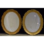 A pair of giltwood oval looking glass/wall mirrors,