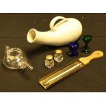 A 19th century clear glass invalid feeder; a green glass eye bath; another,