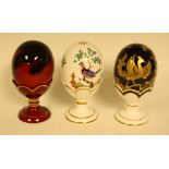Ceramics - a Royal Doulton flambe egg on stand; a Minton egg on stand,