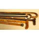 Walking sticks - a Victorian silver topped malaca walking cane, London 18**; others,