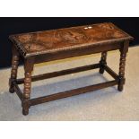A carved oak rectangular stool, with central and carved leaves to angles, bobbin turned legs,