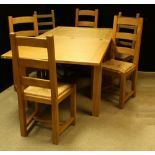 A contemporary fold-out dining table; a set of four conforming rush seated dining chairs;