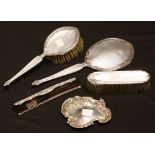 A silver three piece vanity set, Birmingham 1956; a silver pin dish,