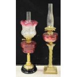A Victorian brass and cranberry glass oil lamp,