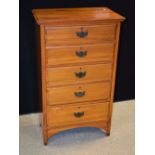 A late Victorian satin walnut chest of drawers, of narrow proportions, c.