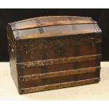 A domed wooden bound travelling trunk