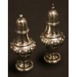 A pair of Edwardian silver peppers,