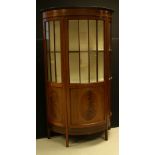 An early-mid 20th century mahogany bow-front display cabinet