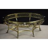 A large brass coffee table, in the Classical taste, oval glass top,