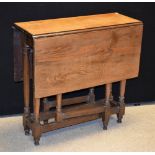 An oak gateleg table, rectangular top with fall leaves, turned supports, rectangular stretchers,