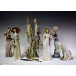 A Lladro figure, Dressmaker; others similar; a Lladro figure group,