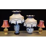 A Chinese inspired blue and white table lamp; another similar;