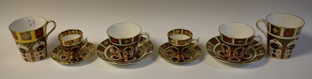 A pair of Royal Crown Derby 1128 pattern tea cup and saucers; another pair,
