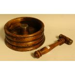 A hardwood nutcracker, ribbed circular holder,