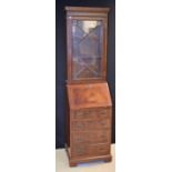 A George III design mahogany bureau bookcase of narrow proportions,