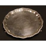 A hallmarked silver shaped circular salver, gadrooned border, claw feet, Sheffield 1975, 20.