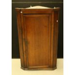 A George III oak corner cupboard, c.