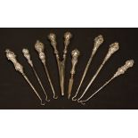 A collection of silver button hooks, etc,