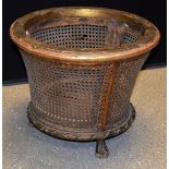 An early 20th century giltwood flared cylindrical bin, canework sides, paw feet,
