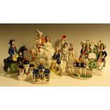 A 19th century Staffordshire flatback figure, Robbie Burns and his Mary; others, spill vases,