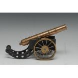 A scratch-built black painted and polished brass and steel model desk cannon, spoked wheels,
