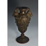 A 19th century dark patinated bronze vase, boldly cast with stags' heads and trailing ivy,