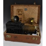 A late Victorian black lacquered and brass magic lantern, canted pine plinth, 43.5cm long, c.