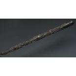 A 19th century Irish bog oak walking stick, carved in relief with shamrocks and ferns,