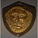A museum type gilt metal model, after the Golden Mask of Agamenon, King of Mycenae, 17cm wide,