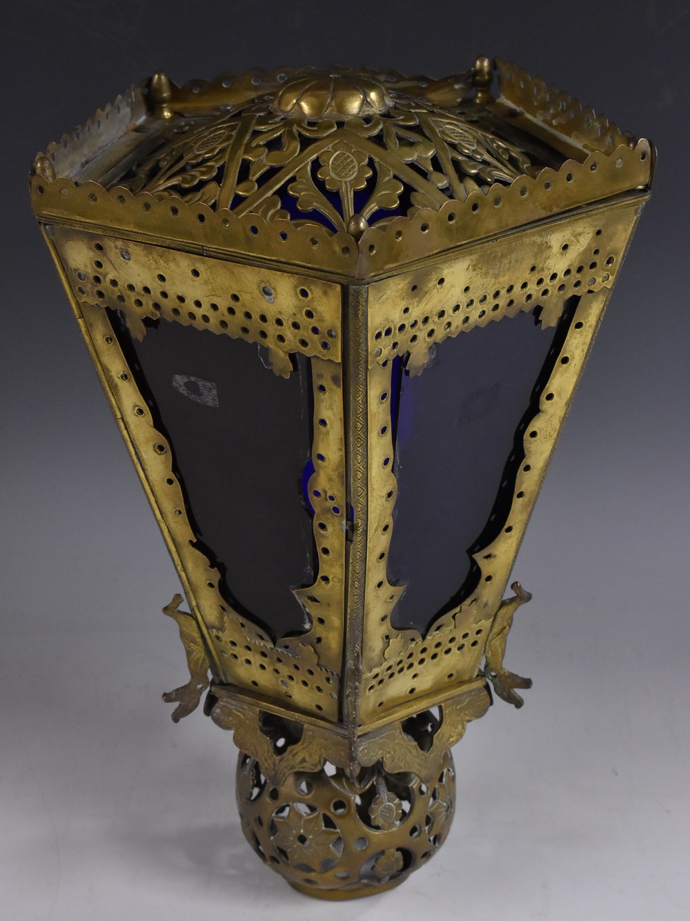 A Moorish brass pentagonal lantern, pierced with flowers, leafy scrolls, and roundels,