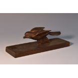 A novelty desk clip, carved as a song bird, the sprung articulated beak operated by the tail,