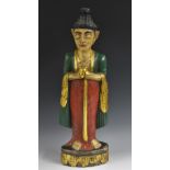 A Chinese polychrome carving, of Buddha, standing, holding a lotus, 63.