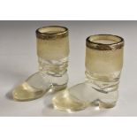 A pair of Edwardian silver mounted glass novelty table vestas or match strikers, as a pair of boots,