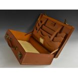 A mid-20th century gentleman's tan leather brief case, hinged cover,